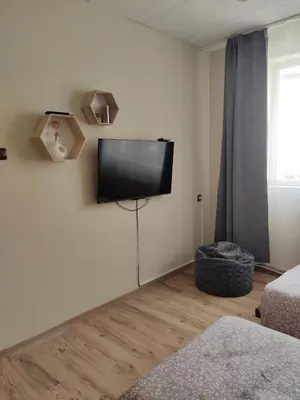 a living room with a flat screen tv on the wall at Тристаен апартамент in Elin Pelin
