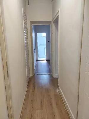 an empty hallway with a hallway leading to a door at Тристаен апартамент in Elin Pelin