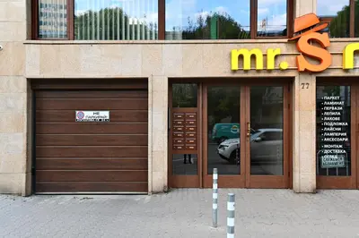 a building with two garage doors and a mris sign at Zlati`s house 2 in Sofia