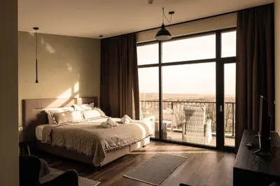 a bedroom with a bed and a large window at Luxury House Veles in Hisarya
