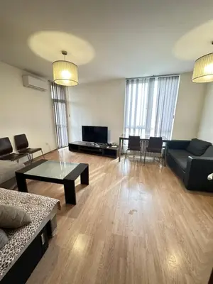 a living room with a couch and a table at The Leverage in Sofia