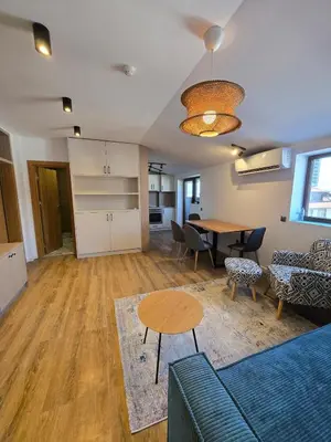 a living room with a couch and a table at KS Gondola point apartment in Bansko