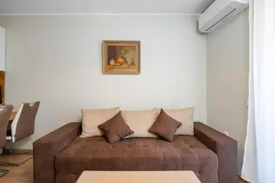 a living room with a couch with pillows on it at 1BD Apartment in Sofia City Center by Flat Mаnаger in Sofia