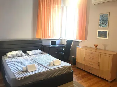 a bedroom with a bed and a desk and a chair at Beautiful Business Apartment - Ivan Denkoglu Street by Flat Mаnager in Sofia