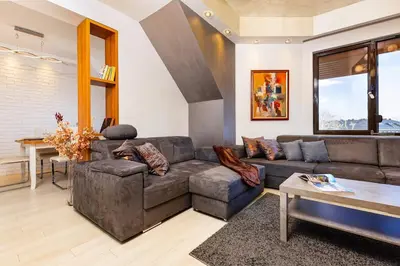 a living room with a couch and a table at City Castle apartment 3BR in central Plovdiv in Plovdiv
