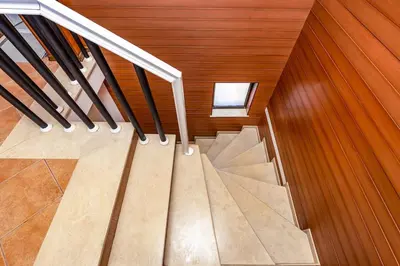 a staircase in a house with wooden walls and a window at City Castle apartment 3BR in central Plovdiv in Plovdiv