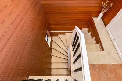 a spiral staircase in a house with wooden floors at City Castle apartment 3BR in central Plovdiv in Plovdiv