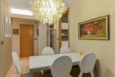 a dining room with a white table and chairs at Stylish One-bedroom Flat with Amazing City View by Flat Mаnаger in Sofia