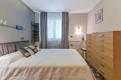 a bedroom with a large bed and a dresser at Stylish One-bedroom Flat with Amazing City View by Flat Mаnаger in Sofia