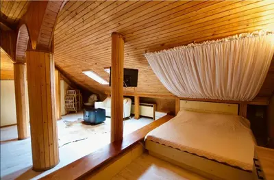 a bedroom with a bed in a wooden room at Къща за гости,, Зафир,, in Sofia
