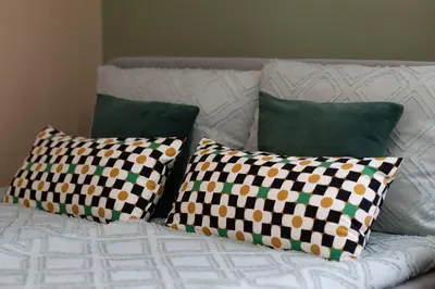 a white couch with three pillows on it at Domus Magnolia Studio In The Top Center in Plovdiv
