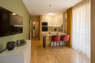 a kitchen with a table and two red chairs at Domus Magnolia Studio In The Top Center in Plovdiv