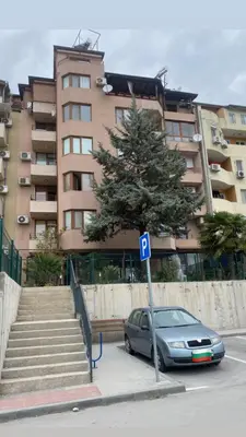 a car parked in front of a large building at Djanina 3 in Sandanski