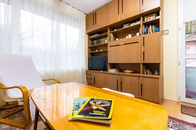 a dining room with a table and a book at Quiet apartment near the center by Flat Mаnager in Plovdiv