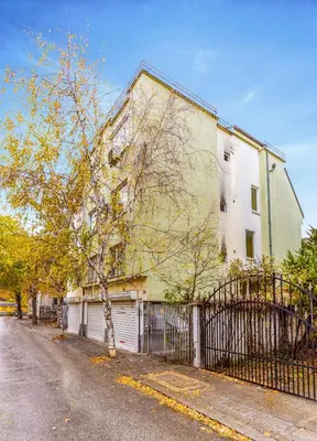 a building on the side of a street with a fence at Quiet apartment near the center by Flat Mаnager in Plovdiv