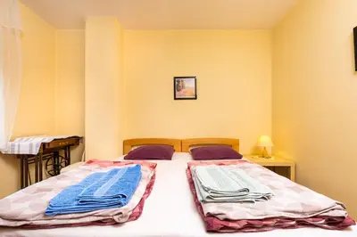 a bedroom with a bed with towels on it at Quiet apartment near the center by Flat Mаnager in Plovdiv