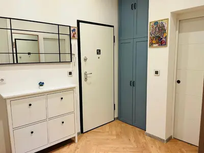 a bathroom with a white dresser and a mirror at Casa Tiempo in Sofia