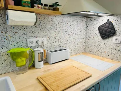 a kitchen counter with a cutting board and a toaster at Casa Tiempo in Sofia
