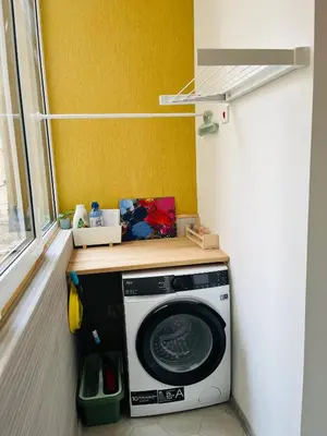 a washing machine in a room with a window at Casa Tiempo in Sofia