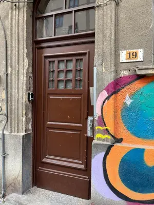 a brown door on the side of a building at Casa Tiempo in Sofia