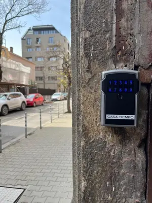 a clock on the side of a brick wall at Casa Tiempo in Sofia