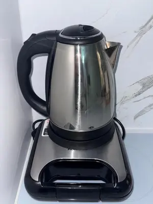 a black and silver coffee maker sitting on a counter at ElenartLux - Baby Cot - Pets Allowed - Free Parking & Fast Wi-Fi in Plovdiv