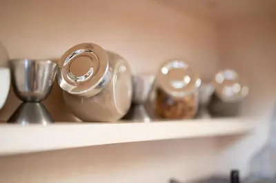 a shelf with several silver utensils on it at Studio Talisman V in Sofia