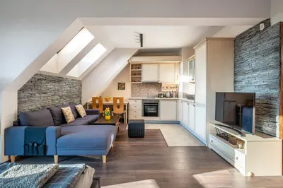 a living room with a blue couch and a kitchen at Studio Talisman V in Sofia