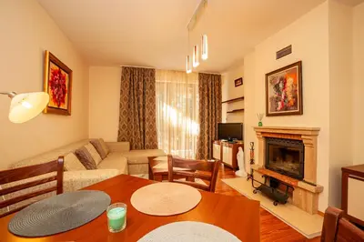 a living room with a couch and a fireplace at Гнездото на Гълъба in Ostrets