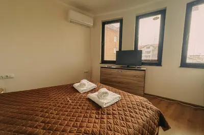 a bedroom with a bed with two towels on it at Apartment Aria 5 in Velingrad