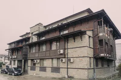 an old building with a car parked in front of it at Apartment Aria 5 in Velingrad