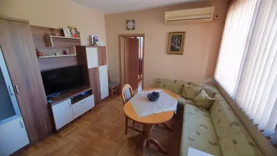 a small living room with a table and a couch at Malina Apart in Plovdiv