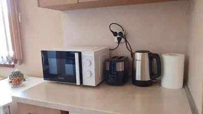 a kitchen counter with a microwave and a coffee maker at Malina Apart in Plovdiv