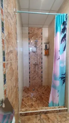 a shower with a glass door in a bathroom at Malina Apart in Plovdiv