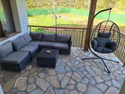 a living room with a couch and a table at Къща за гости Брязово in Ribarica