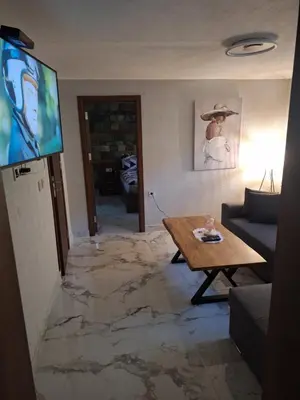 a living room with a floor covered in marble at Къща за гости Брязово in Ribarica