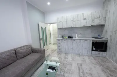a living room with a couch and a kitchen at Secret Guest House in Plovdiv