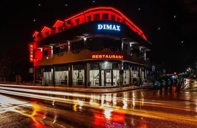 a building on a city street at night at Hotel-Restaurant DIMAX in Yoakim-Gruevo