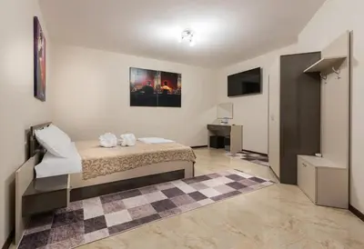 a bedroom with a bed and a desk in it at Hotel-Restaurant DIMAX in Yoakim-Gruevo