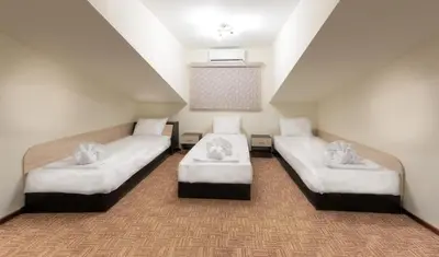 a room with two beds in a room at Hotel-Restaurant DIMAX in Yoakim-Gruevo