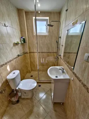a bathroom with a toilet and a sink and a shower at Къща за гости Спирката in Spatovo