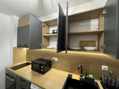 a kitchen with a sink and a microwave at The View Residences & private parking in Sofia