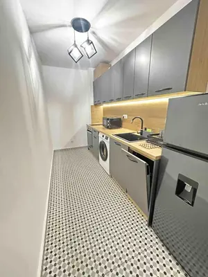 a kitchen with a washing machine and a sink at The View Residences & private parking in Sofia