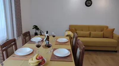 a dining room table with glasses of wine and fruit on it at Sofia Harmony Tranquility Comfort and Free Parking in Sofia
