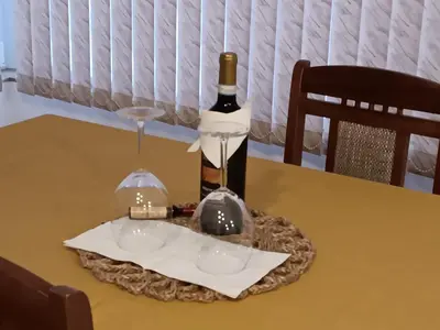 a bottle of wine and a glass on a table at Sofia Harmony Tranquility Comfort and Free Parking in Sofia