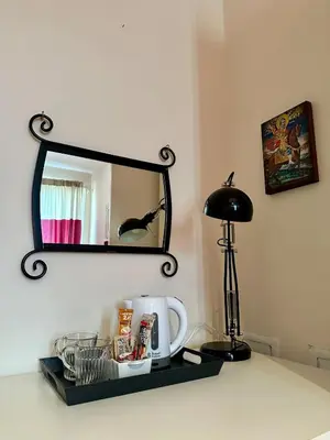 a shelf with a mirror and a lamp on a counter at Mary's Guesthouse in Banya