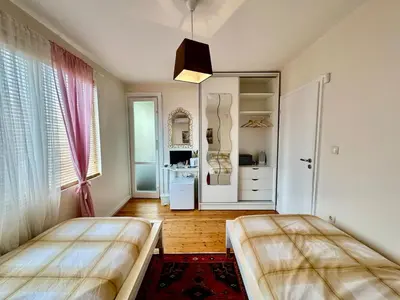 a bedroom with two beds and a large window at Mary's Guesthouse in Banya
