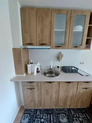 a kitchen with a sink and wooden cabinets at Apartment B5 5 Relax Chamkoria Borovets in Borovets
