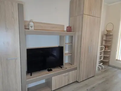 a entertainment center with a flat screen tv in a room at The Nest in Sofia