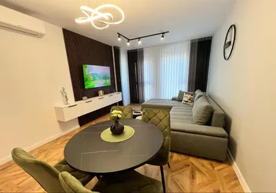 a living room with a table and a couch at City lux apartment in Plovdiv